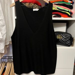 Black v-neck sleeveless sweater.